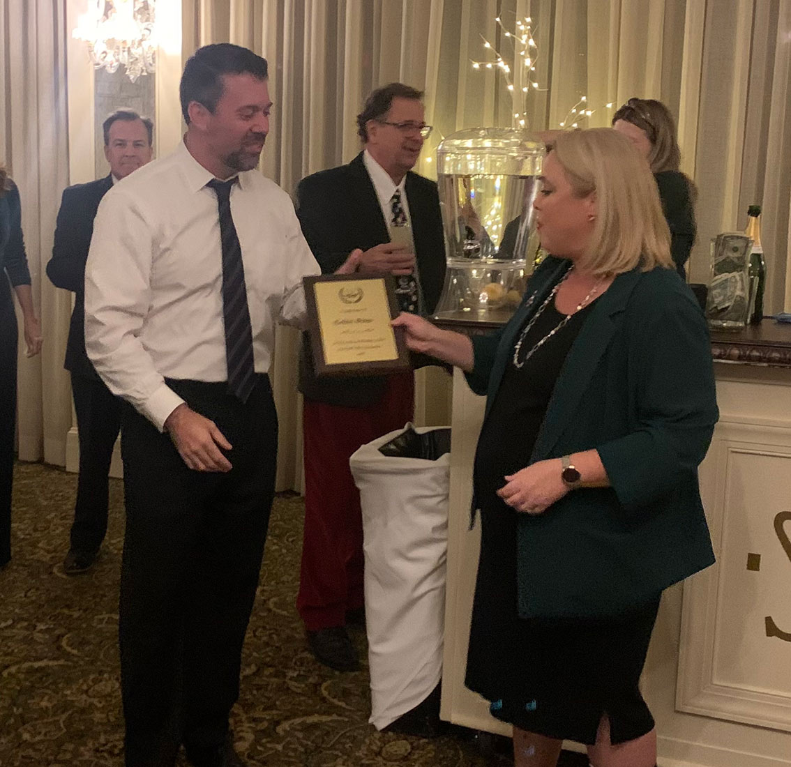 Incoming President Kristen Stanley-Walllace presenting Collin Sims with recognition for his service as 2023 22nd JDC Bar Association President