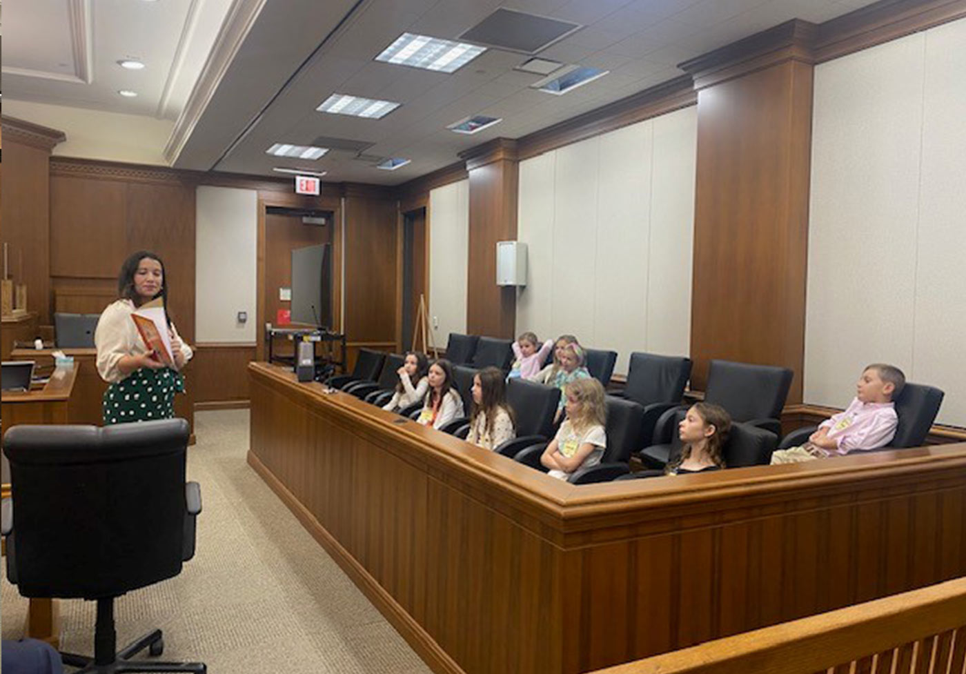 Attorney Ana Lopez and our youngest visitors make good use of the jury box to take a breather and enjoy story time.